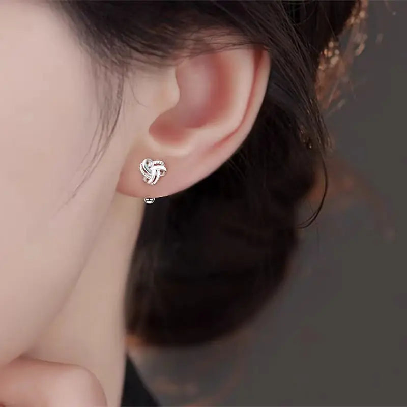 The S925 sterling silver stud earrings symbolize peace and good luck, representing high-end jewelry and a luxurious retro style